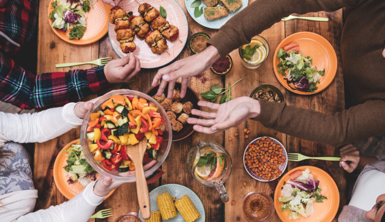 friends-passing-food-dinner-table