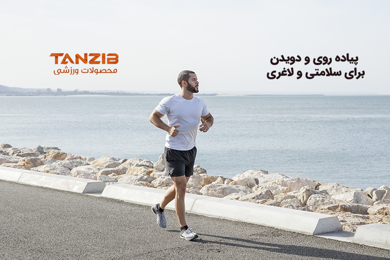 Serious young strong man wearing sportswear and running on seaside road with sea in background